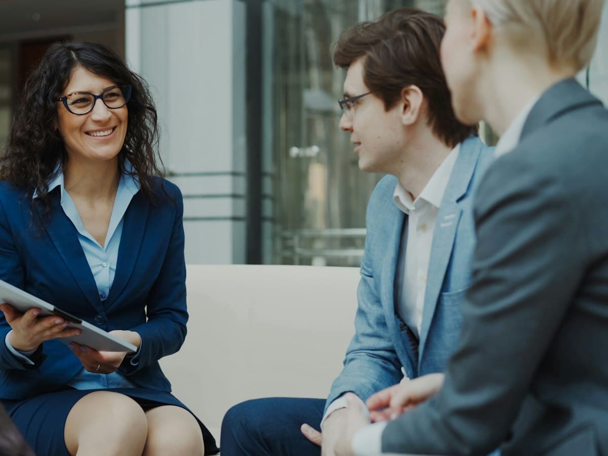 An adviser with a tablet talking with a couple